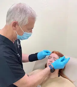 injecting dermal filler into forehead lines
